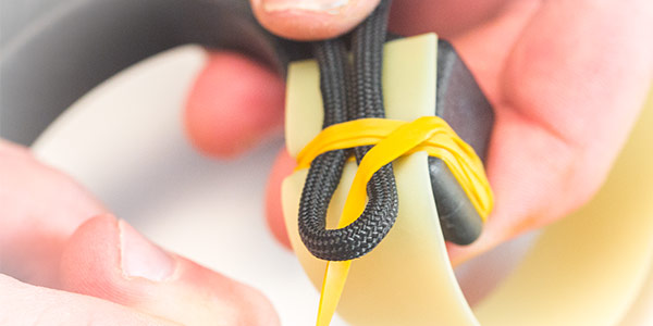 6. Carefully holding the tensioned wraps in place, feed the tag end through the loop. 6. Carefully holding the tensioned wraps in place, feed the tag end through the loop.